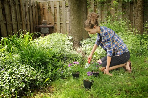 Staff member assisting a visitor with mobility needs in a community garden